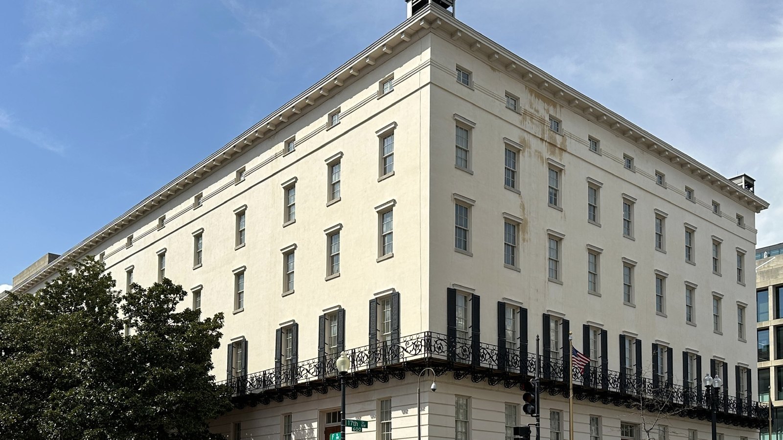 The Winder Building at 600 17th Street NW in Washington, D.C., a five-storey cream building with black shutters and an iron balcony, with a US flag